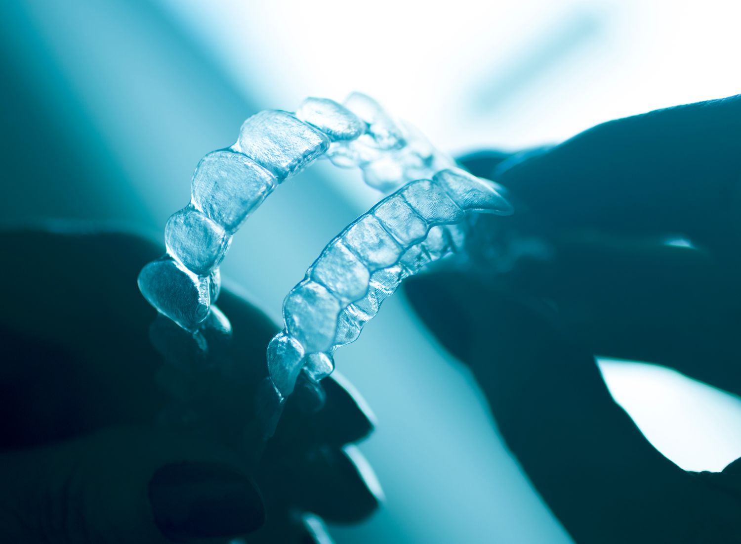 Close-up view of clear retainers for orthodontic care, available at AMC Dental in London.